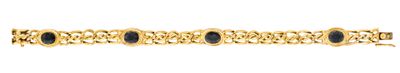 a close up of a gold bracelet with blue stones on it