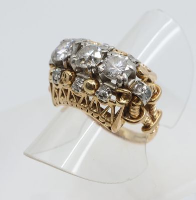 an image of a gold and diamond ring on a clear ring holder
