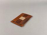 a small wooden comb on a table with a white background