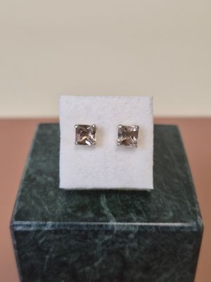 a close up of a pair of earrings sitting on top of a box