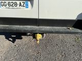 a small yellow object on the ground next to a car