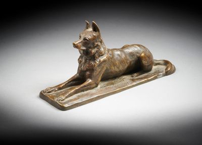 an egyptian bronze statue of a dog on a tray