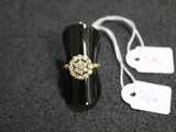 a black ring with a gold and white flower on it
