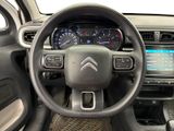 the interior of a car with a steering wheel and dashboard controls