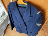 a suit jacket hanging on a hanger in a room