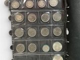 a lot of coins that are in a black case