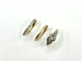 three gold rings with diamonds on them sitting on a white surface