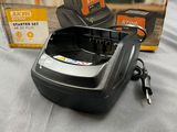 a black and decker battery charger with a box on a bed