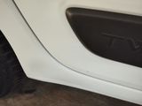 a close up of a white truck with a tv on the door