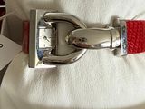 an image of a red belt with a silver buckle