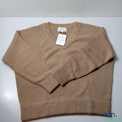 an image of a sweater with a tag on it on a table