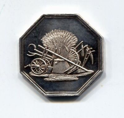 a silver coin with a picture of a man on it