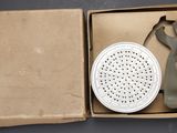 a box with a gas mask and a filter in it
