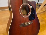 a guitar that is sitting on a hard wood floor
