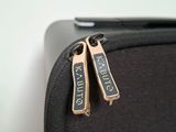 a close up of a piece of luggage with two tags attached to it