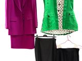 trois vestes et jupes pour femmes suspendues à un portant