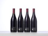 three bottles of wine are lined up on a table
