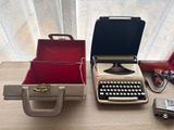 a typewriter and other items sitting on a table