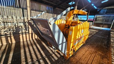 a yellow bulldozer parked inside of a building