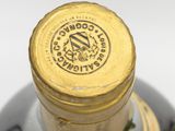 a close up of a bottle of wine with a banana on it