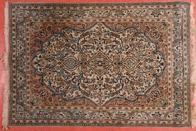 an antique persian rug with a medallion design on a pink background
