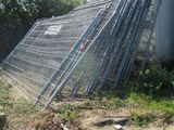 a fence that has been knocked over in front of a building