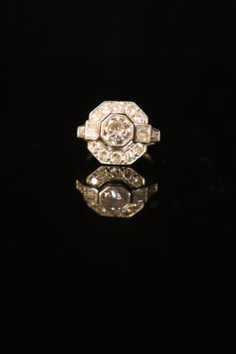 a close up of a diamond ring on a black surface