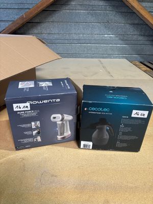 two boxes of coffee machines sitting on top of a cardboard box
