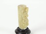 carved ivory figurine of a man on a pedestal