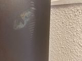 a close up of a silver refrigerator in a kitchen