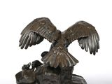an image of a statue of an eagle on a rock with a bird on it