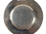a silver plate that has a small hole in the middle