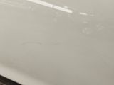 a close up of a white sink with a black handle