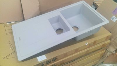 a white plastic sink sitting on top of a cardboard box