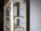 a bird cage that has a bunch of birds inside of it