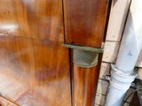 a close up of a wooden cabinet with a metal handle