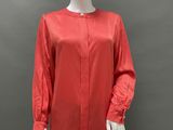 a mannequin mannequin wearing a red blouse and black pants