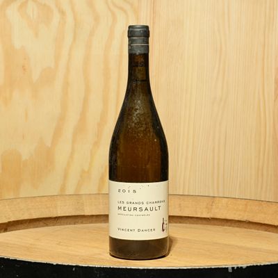 une bouteille de vin posée sur un tonneau