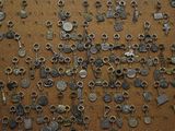 many different types of metal items on a cork board