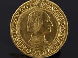 a gold coin with an image of a man on it