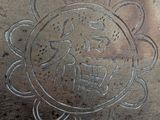 a silver vase with a design on it on a table