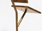 a chair that is sitting on a stand with a laptop on it