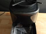an image of a black coffee maker on a wooden table
