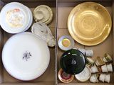 many plates and bowls in a box on the table