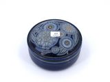 a small blue box with flowers on it on a white surface