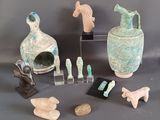 many pieces of pottery that are on display on a table