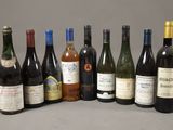several bottles of wine are lined up in a row on a table