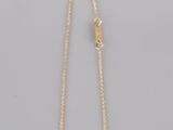 a gold plated necklace with a white druzy stone