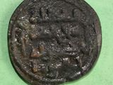 a close up of an old coin on a green surface