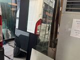 a van that is parked in a garage next to a refrigerator